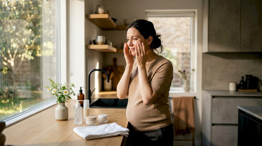 Pregnant woman applying skincare in bathroom
