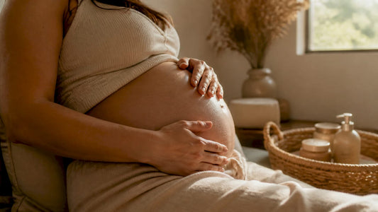 Pregnant woman massaging belly oil