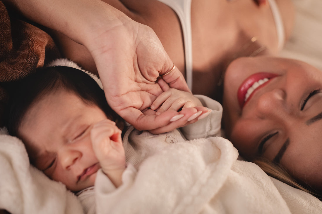 New mother resting with her newborn in nursery