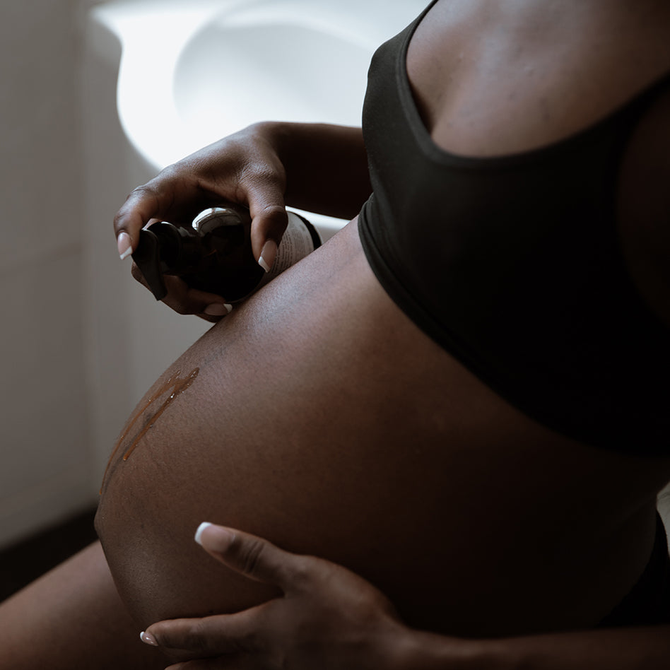 Pregnancy bump and body oil being applied to growing bump, lightweight and fast-absorbing